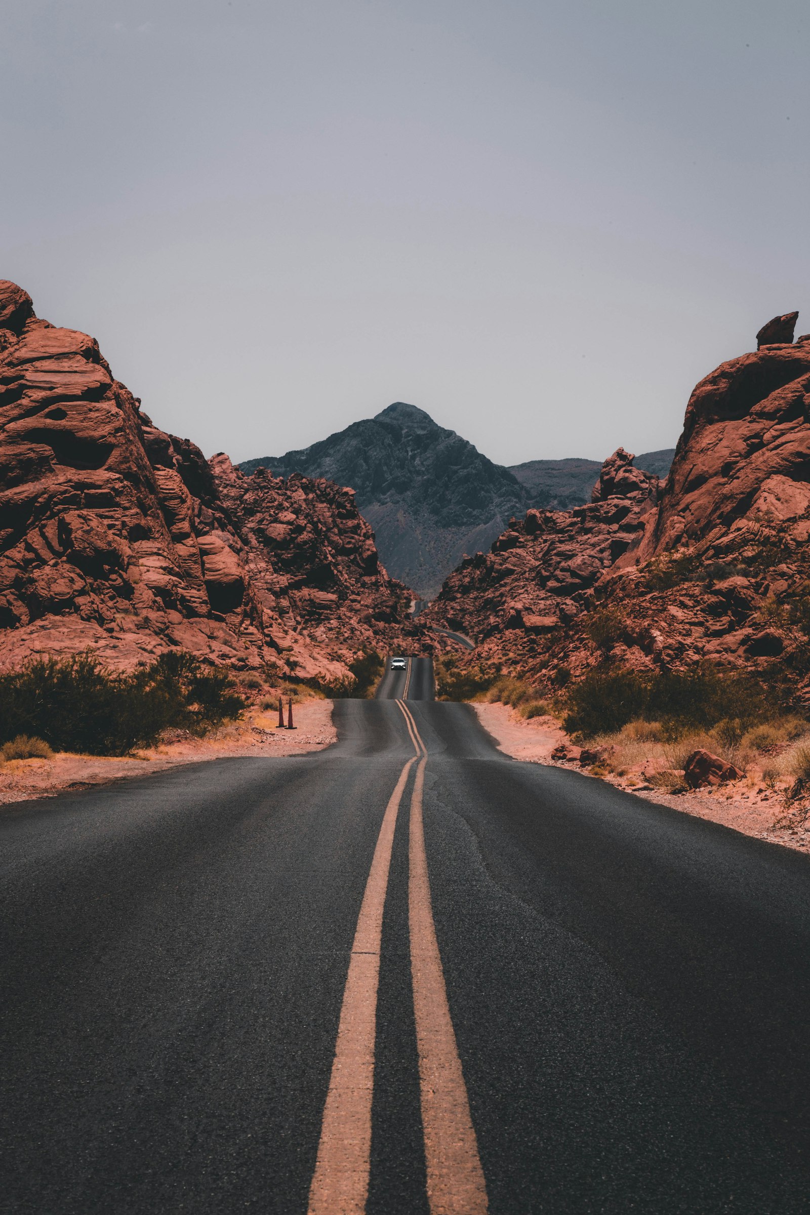 A winding canyon road through golden hills at dusk